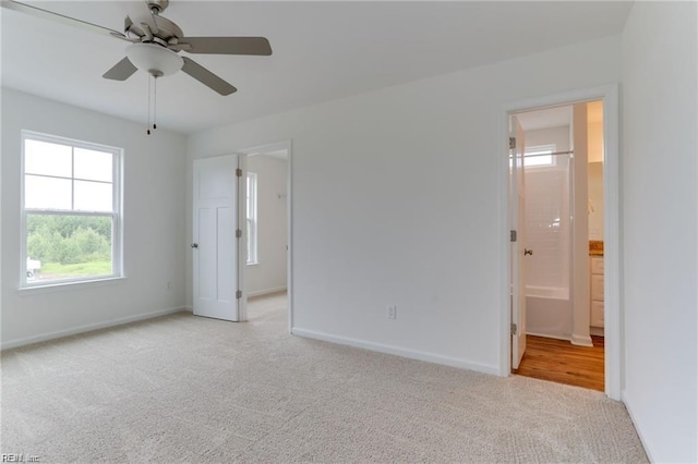 carpeted empty room featuring ceiling fan