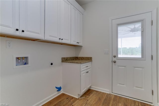 washroom featuring hookup for an electric dryer, hookup for a washing machine, cabinets, and light hardwood / wood-style floors