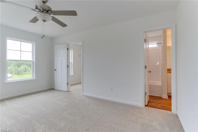 empty room featuring light carpet and ceiling fan