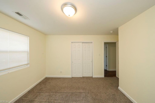 unfurnished bedroom with carpet floors and a closet