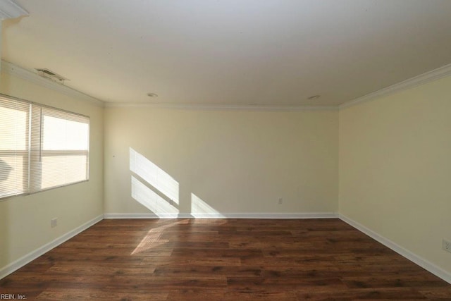 spare room with crown molding and dark wood-type flooring