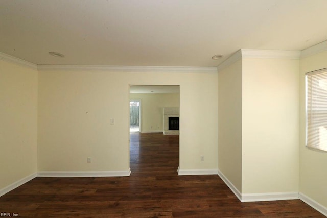 unfurnished room featuring dark hardwood / wood-style flooring and ornamental molding