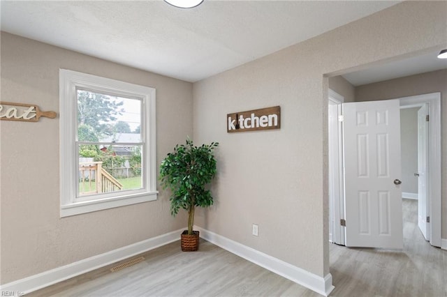 spare room with light wood-type flooring