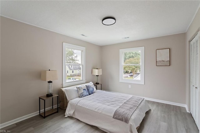 bedroom featuring hardwood / wood-style flooring and a closet