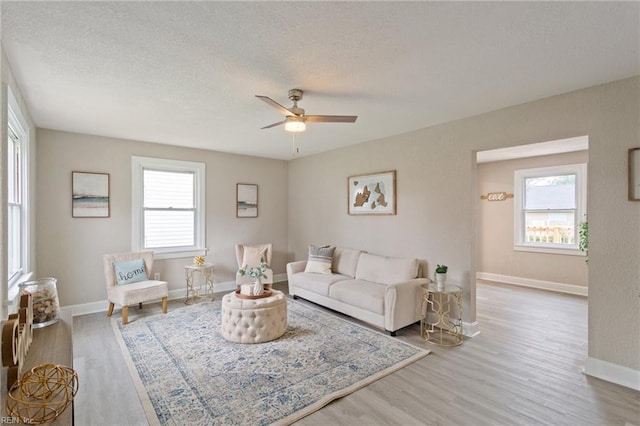 living room with hardwood / wood-style floors and ceiling fan