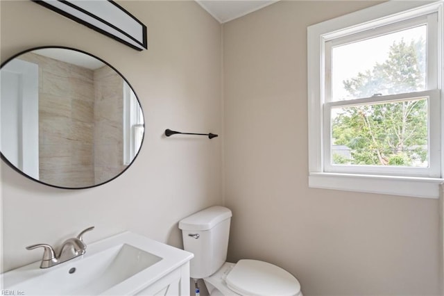 bathroom with plenty of natural light, vanity, and toilet