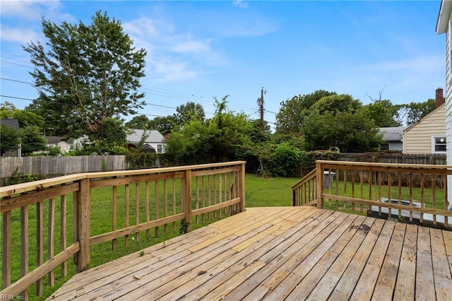 wooden terrace featuring a lawn