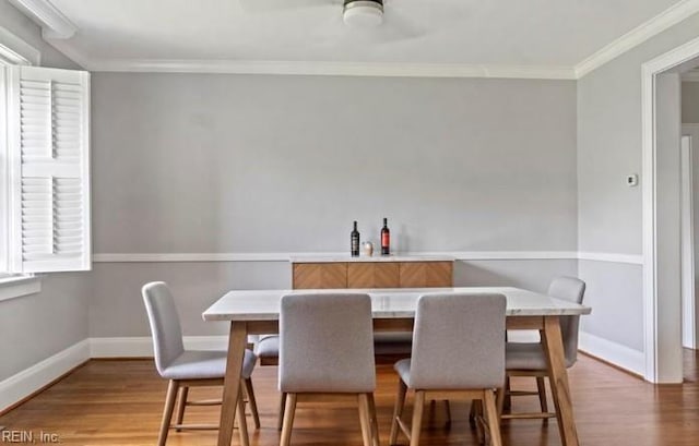 dining room featuring hardwood / wood-style floors and crown molding