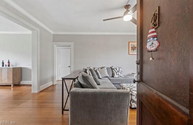 living room with ceiling fan, wood-type flooring, and ornamental molding