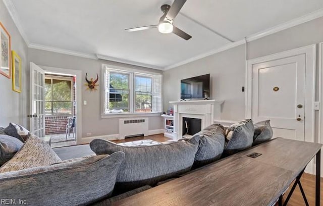 living room with ceiling fan, radiator heating unit, hardwood / wood-style flooring, and ornamental molding