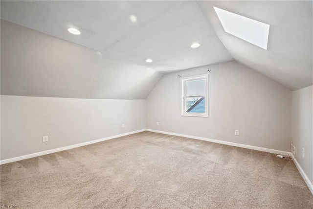 bonus room with carpet floors and lofted ceiling with skylight