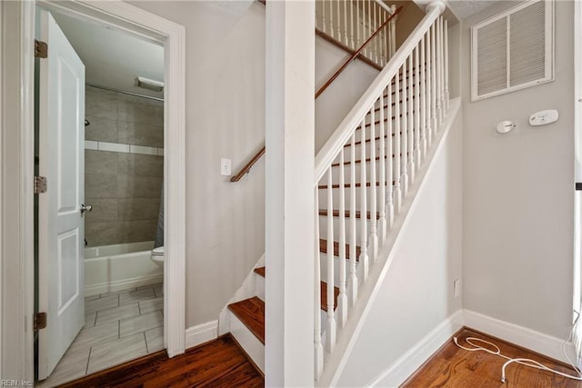 staircase with wood-type flooring