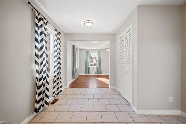 corridor with light tile patterned floors