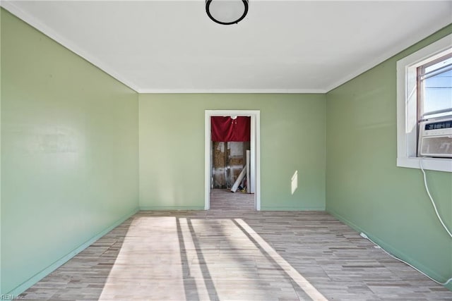 spare room with light hardwood / wood-style floors and ornamental molding