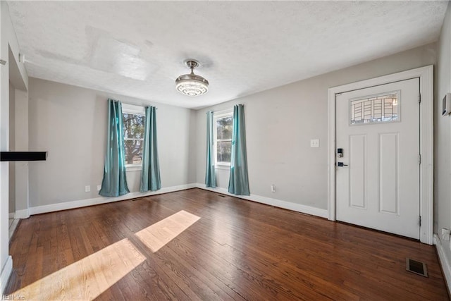 foyer entrance with dark wood-type flooring