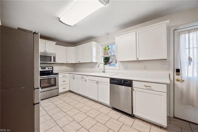 kitchen featuring white cabinetry, sink, and appliances with stainless steel finishes