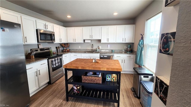 kitchen featuring white cabinetry, sink, appliances with stainless steel finishes, and dark wood-type flooring