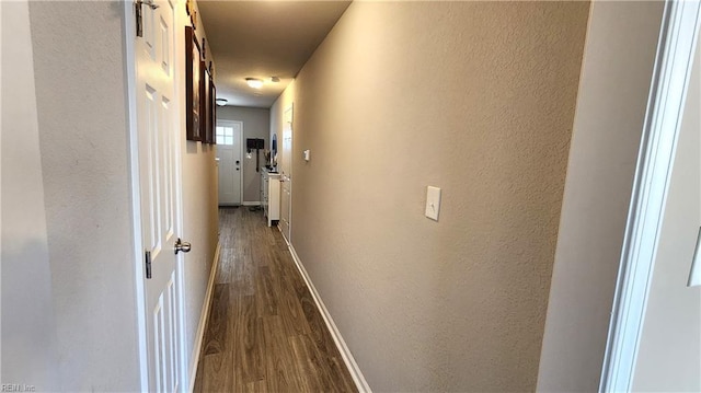 corridor with wood-type flooring