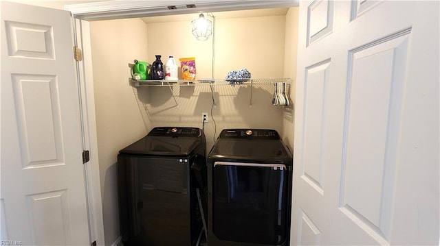 clothes washing area featuring washer and clothes dryer