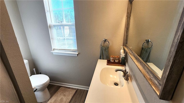 bathroom with sink, wood-type flooring, and toilet