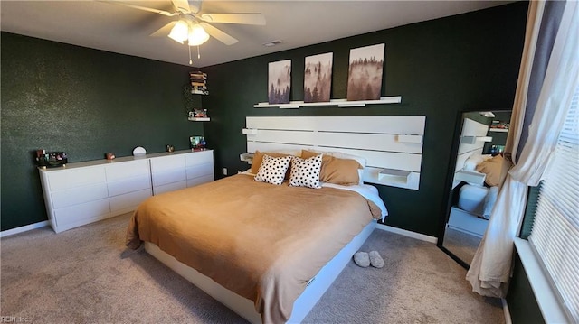 bedroom with ceiling fan and light carpet