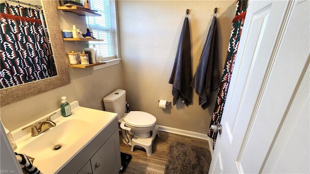 bathroom with hardwood / wood-style flooring, vanity, and toilet