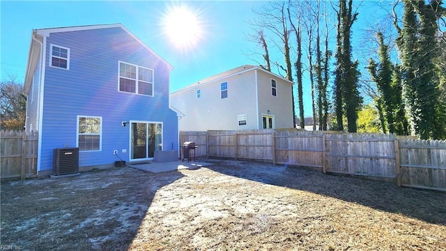 back of house with central AC unit