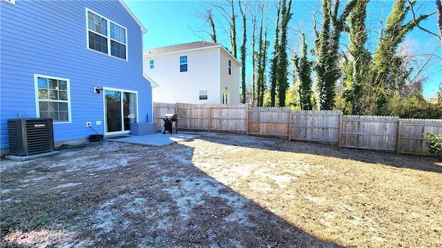 view of yard with cooling unit and a patio area