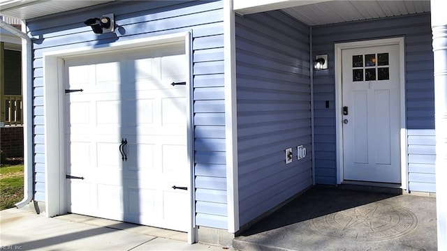 doorway to property with a garage