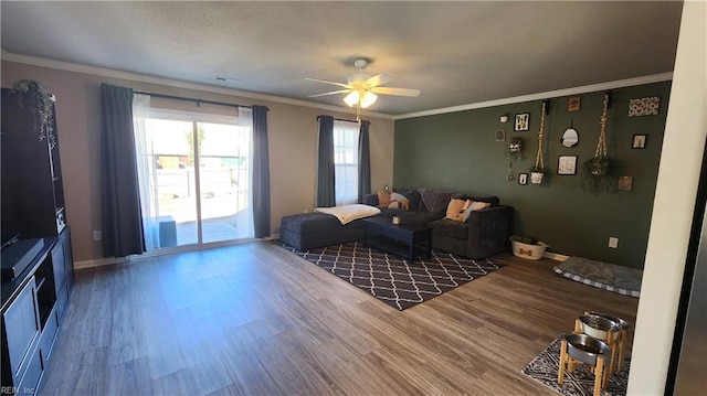 living room with ceiling fan, wood-type flooring, and ornamental molding