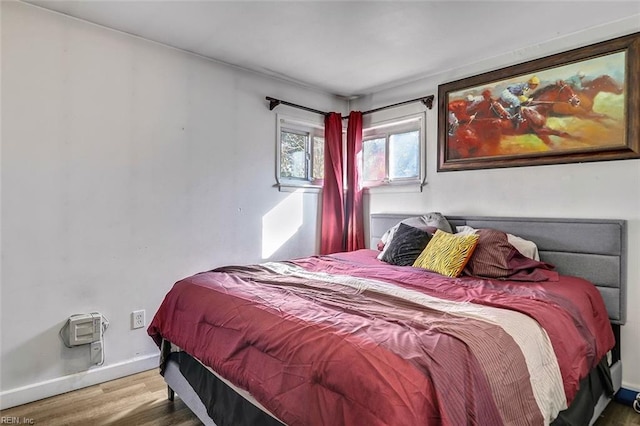 bedroom with hardwood / wood-style floors