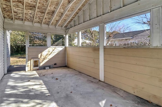 unfurnished sunroom featuring lofted ceiling