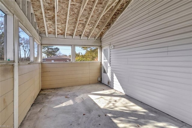 unfurnished sunroom featuring lofted ceiling