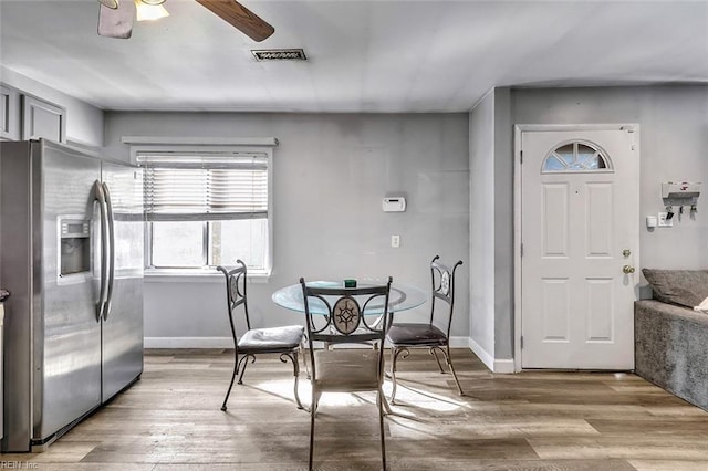 dining area featuring light hardwood / wood-style flooring and ceiling fan