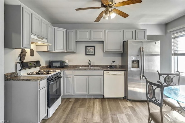 kitchen with gray cabinetry, sink, white appliances, and light wood-type flooring