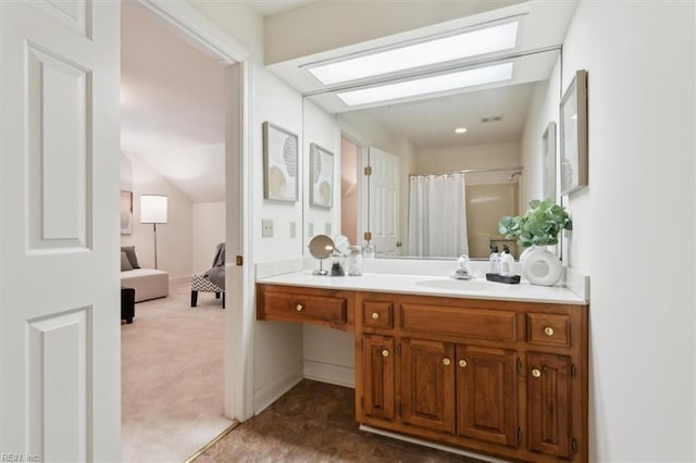 bathroom with curtained shower and vanity