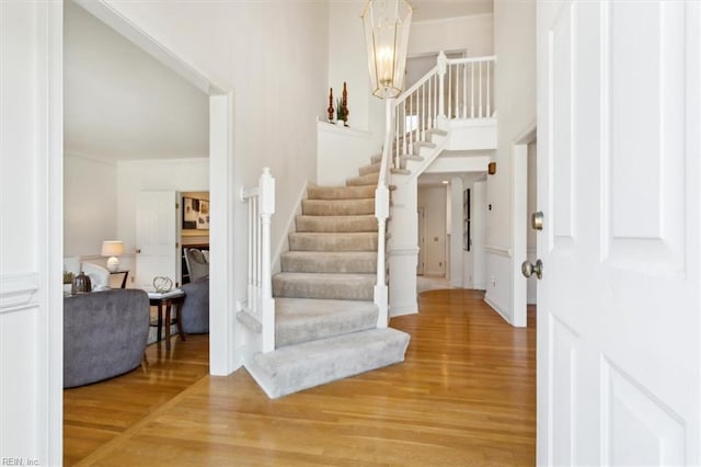 foyer with hardwood / wood-style floors and a chandelier