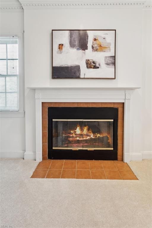 room details with a tiled fireplace and carpet floors