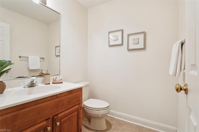 bathroom featuring tile patterned flooring, vanity, and toilet