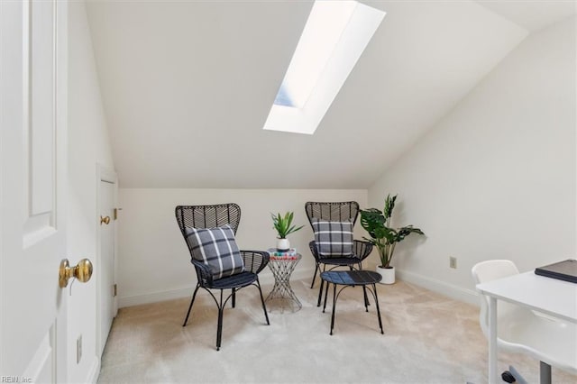 living area with vaulted ceiling with skylight and light carpet