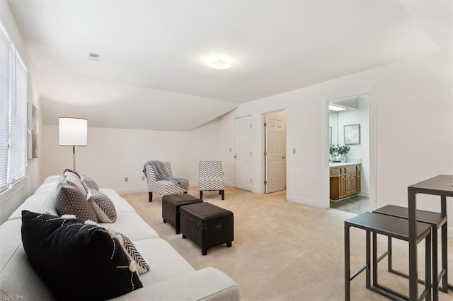 carpeted living room with lofted ceiling