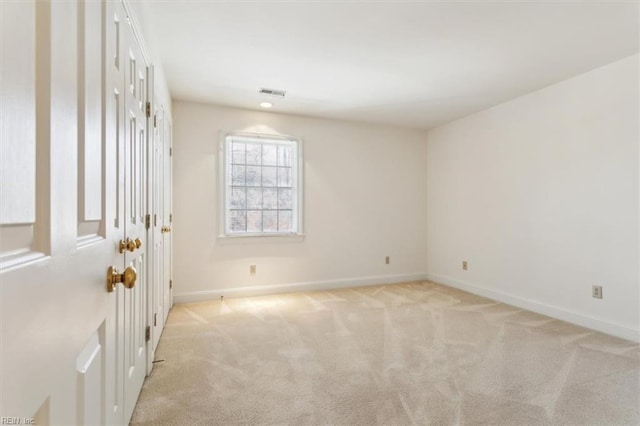 empty room featuring light carpet