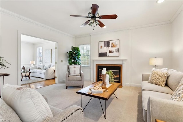 living room with light colored carpet, ceiling fan, and crown molding