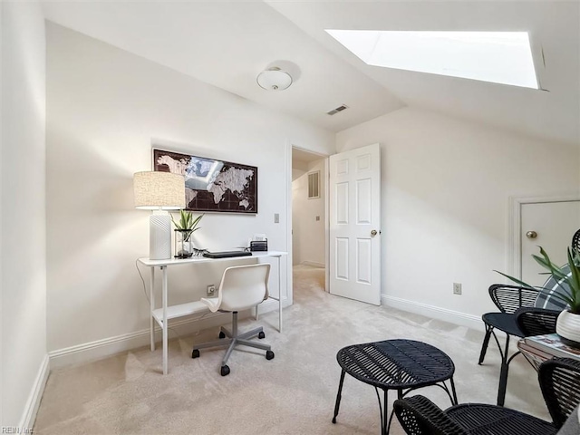 office space featuring lofted ceiling with skylight and light carpet