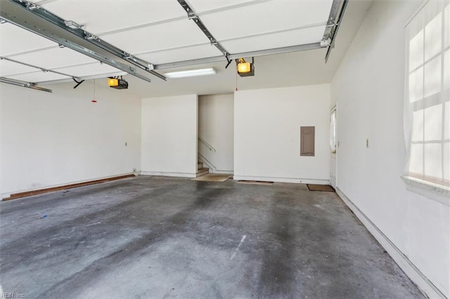 garage featuring electric panel and a garage door opener