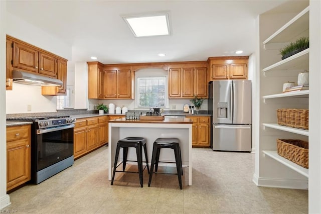 kitchen featuring a breakfast bar area, a center island, and appliances with stainless steel finishes