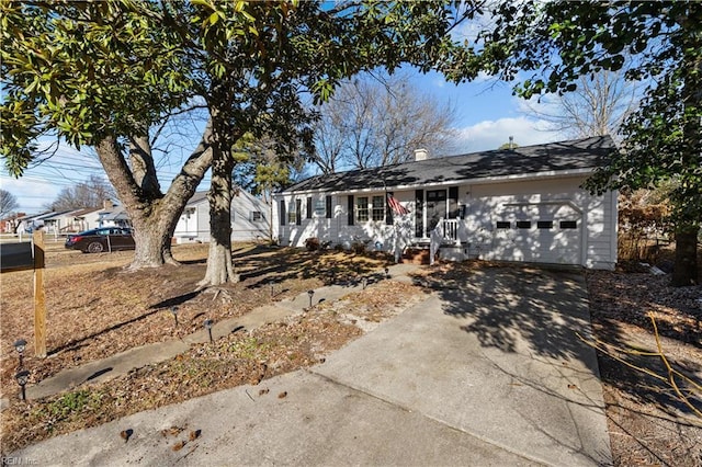 single story home with concrete driveway and an attached garage