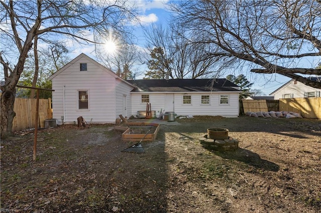 back of house with a vegetable garden, cooling unit, and a fenced backyard