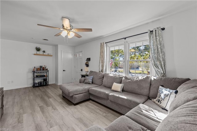 living room with ceiling fan and light wood-type flooring