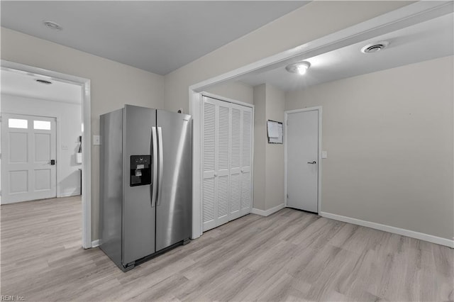 kitchen with stainless steel fridge with ice dispenser and light hardwood / wood-style flooring